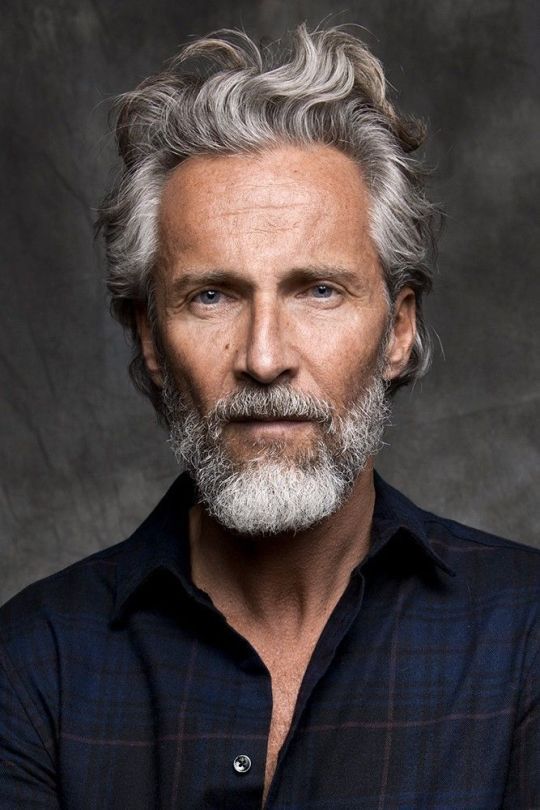 Gray-bearded man with layered neutrals