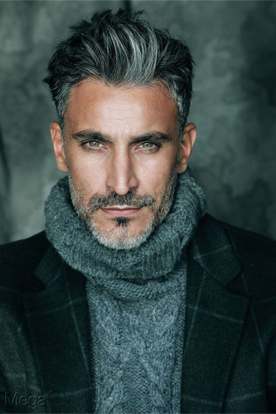 Gray-bearded man in navy overcoat and sophisticated winter style