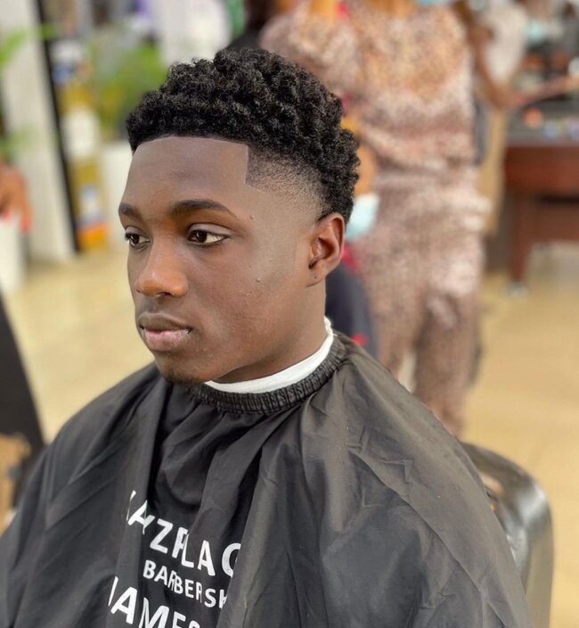 Sponge curls with tapered sides hairstyle for Black men