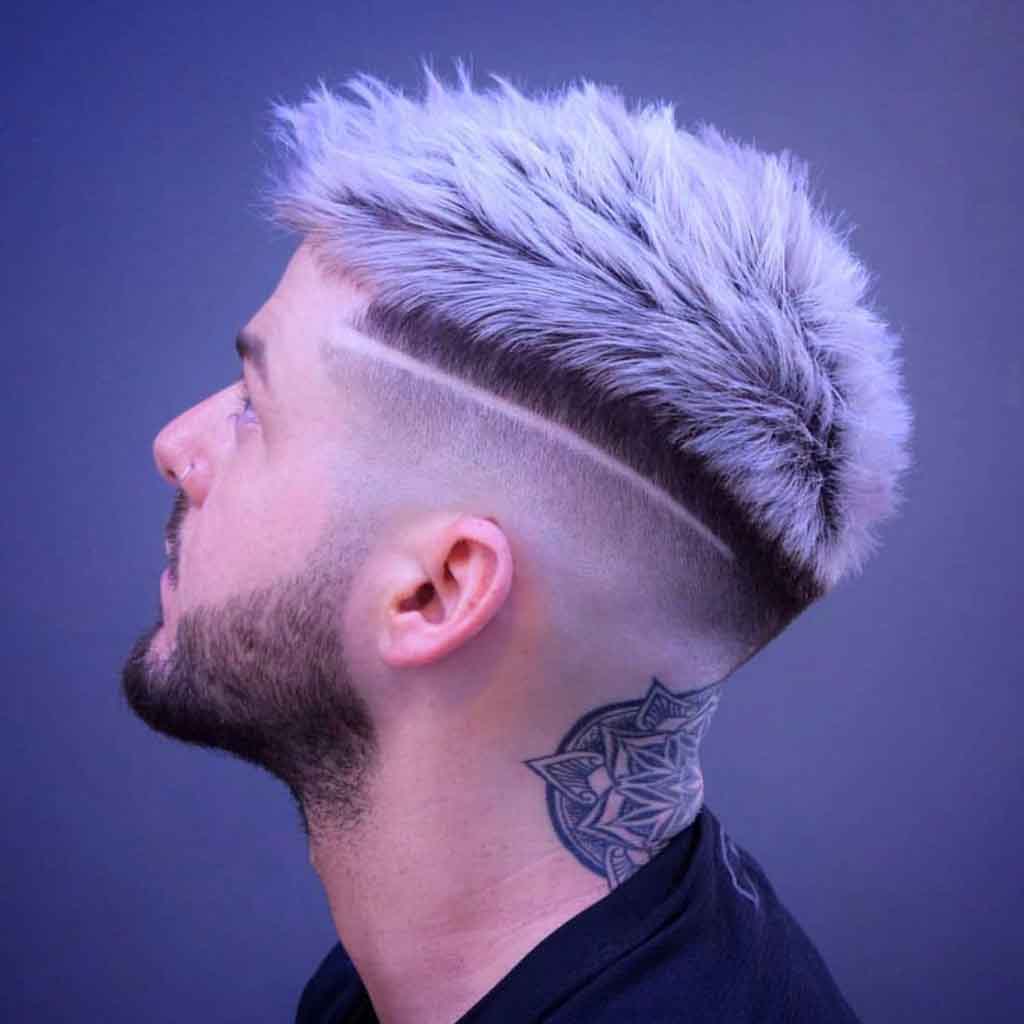 Disconnected fade haircut with spiky textured top for a dynamic and edgy streetwear look