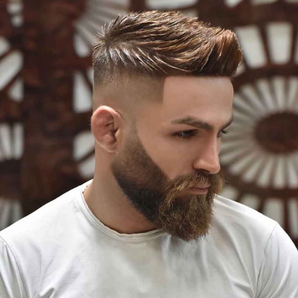 High textured quiff paired with a low fade for a bold yet refined streetwear look