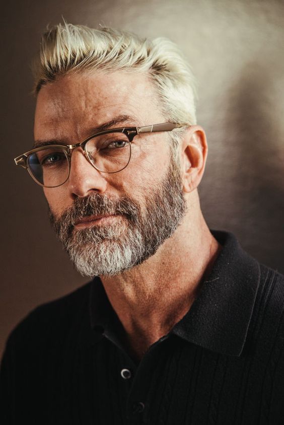 Gray-bearded man in sleek monochrome outfit