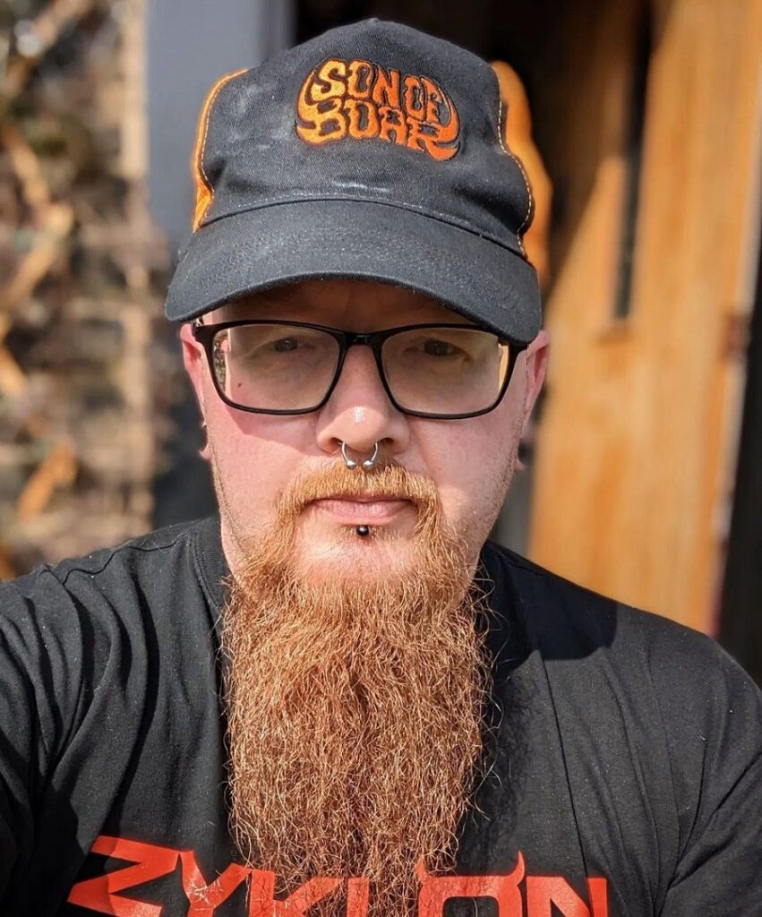 Extended Goatee with Bold Mustache and Low Fade